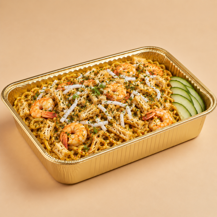Quentin’s dry laksa with prawns and sliced cucumber in a gold mini buffet tray