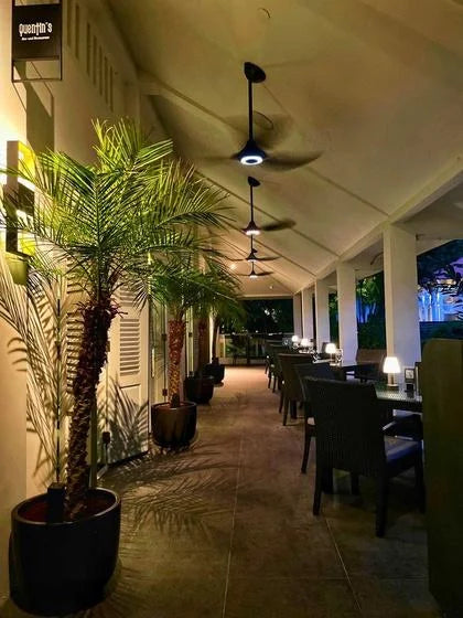 Covered outdoor terrace at Quentin’s with greenery